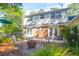Seating area in backyard with brick patio, ferns, and a fire pit at 1521 Wren Ave, Mount Pleasant, SC 29464