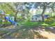 A spacious backyard features a play set and lush landscaping, ideal for outdoor activities and Gathering gatherings at 1521 Wren Ave, Mount Pleasant, SC 29464