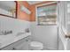 Cozy bathroom with white wainscoting, neutral colors, and a window for natural light at 1521 Wren Ave, Mount Pleasant, SC 29464