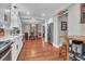 Modern kitchen featuring white cabinets, stainless appliances, and hardwood floors leading to dining area at 1521 Wren Ave, Mount Pleasant, SC 29464