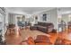 Open living area with hardwood floors, plush sofa, and a view into the dining space at 1521 Wren Ave, Mount Pleasant, SC 29464