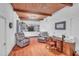 Living room with wood ceilings, hardwood floors, built-in shelves, and comfortable seating at 1521 Wren Ave, Mount Pleasant, SC 29464