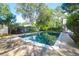 A sparkling in-ground pool is surrounded by a patio and lush greenery, ideal for relaxing and enjoying the outdoors at 1521 Wren Ave, Mount Pleasant, SC 29464