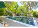 A refreshing pool sits amongst mature trees and a lush green yard, creating a serene outdoor oasis at 1521 Wren Ave, Mount Pleasant, SC 29464