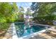 Backyard pool surrounded by lush landscaping offers a private retreat at 1521 Wren Ave, Mount Pleasant, SC 29464