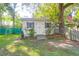 A charming shed with gray shutters offers additional storage space and blends seamlessly with the backyard landscape at 1521 Wren Ave, Mount Pleasant, SC 29464