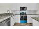 Bright kitchen with granite counters, stainless steel appliances and white cabinetry offers style and function at 1631 Camfield Ln, Mount Pleasant, SC 29466