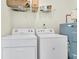 A functional laundry room with white appliances and shelving, ready for all your laundry needs at 1631 Camfield Ln, Mount Pleasant, SC 29466