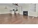 Open living room space features hardwood floors, a ceiling fan, fireplace, and white walls at 1631 Camfield Ln, Mount Pleasant, SC 29466