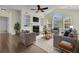 Bright living room features a ceiling fan, fireplace, hardwood floors, and a large window at 1631 Camfield Ln, Mount Pleasant, SC 29466
