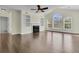 Open living room featuring hardwood floors, a ceiling fan, fireplace, and a large window at 1631 Camfield Ln, Mount Pleasant, SC 29466