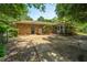 View of brick home showcasing backyard patio and well-maintained landscaping, perfect for outdoor enjoyment at 1655 Pinckney Park Dr, Charleston, SC 29407