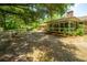 A screened-in porch provides a relaxing space overlooking the spacious, tree-lined backyard at 1655 Pinckney Park Dr, Charleston, SC 29407