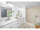 Modern bathroom with double sink vanity, framed mirrors and glass shower with stone pebble floor at 1655 Pinckney Park Dr, Charleston, SC 29407