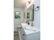 Updated bathroom featuring granite countertops, a sleek vanity, mirror, and plenty of natural light at 1655 Pinckney Park Dr, Charleston, SC 29407