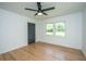 Bright bedroom featuring hardwood floors, a ceiling fan, and a double-window allowing ample natural light at 1655 Pinckney Park Dr, Charleston, SC 29407
