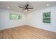 Bedroom with two windows, hardwood floors, white walls and ceiling fan at 1655 Pinckney Park Dr, Charleston, SC 29407