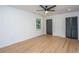 Bright bedroom with hardwood floors, ceiling fan, two closets and a window offering plenty of natural light at 1655 Pinckney Park Dr, Charleston, SC 29407