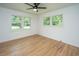Bright, airy room with hardwood floors, two windows and a ceiling fan at 1655 Pinckney Park Dr, Charleston, SC 29407