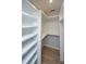 Walk-in closet with built-in shelving units, white paint and hardwood floor at 1655 Pinckney Park Dr, Charleston, SC 29407