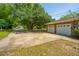 Spacious driveway leads to a two-car garage, complemented by a large, shady tree in front at 1655 Pinckney Park Dr, Charleston, SC 29407