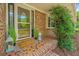 Inviting front porch with brick facade, mosaic tile, and decorated with green plants and a welcome mat at 1655 Pinckney Park Dr, Charleston, SC 29407