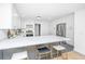 Modern kitchen featuring white cabinetry, a stainless-steel refrigerator, and an expansive quartz countertop bar at 1655 Pinckney Park Dr, Charleston, SC 29407