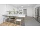 Beautiful kitchen with white cabinetry, gray flooring, stainless steel appliances, and a spacious breakfast bar at 1655 Pinckney Park Dr, Charleston, SC 29407