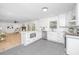 Renovated kitchen featuring white cabinetry, modern appliances, and seamless integration to the living space at 1655 Pinckney Park Dr, Charleston, SC 29407