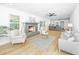 Bright living room featuring a fireplace, hardwood floors, a ceiling fan, and open concept to the kitchen at 1655 Pinckney Park Dr, Charleston, SC 29407