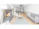 Spacious living room with a fireplace, hardwood floors, and seamlessly connected to the adjacent kitchen at 1655 Pinckney Park Dr, Charleston, SC 29407