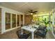 Inviting screened patio, complete with dining table, chairs, ceiling fan, and serene outdoor views at 1655 Pinckney Park Dr, Charleston, SC 29407