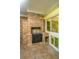 Brick fireplace with black metal door in corner of screened patio at 1655 Pinckney Park Dr, Charleston, SC 29407
