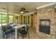 Inviting screened patio with dining table, chairs, fireplace, and serene outdoor views at 1655 Pinckney Park Dr, Charleston, SC 29407
