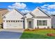 Charming single-story home with a two-car garage, manicured lawn, and classic white siding at 1671 Grange Cir, Summerville, SC 29486
