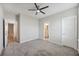 Bedroom with gray carpet, ceiling fan and ensuite bathroom featuring white trim at 1671 Indy Dr, North Charleston, SC 29405