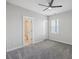 Bedroom featuring gray carpet, ceiling fan and natural light with ensuite bathroom at 1671 Indy Dr, North Charleston, SC 29405