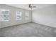 Bright, carpeted bedroom with three large windows providing ample natural light at 1671 Indy Dr, North Charleston, SC 29405