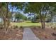 Picturesque view of a green community space with mature trees and walking paths at 1671 Indy Dr, North Charleston, SC 29405