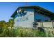 Mixon's galvanized metal exterior is surrounded by a wooden fence and tropical plants at 1671 Indy Dr, North Charleston, SC 29405