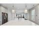 Bright kitchen with a quartz island and stainless steel appliances overlooking the living room at 1671 Indy Dr, North Charleston, SC 29405