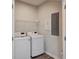 Bright laundry area features a modern washer and dryer, wire shelving, and stylish flooring at 1671 Indy Dr, North Charleston, SC 29405
