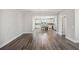 An open-concept living room and kitchen with hardwood floors and elegant lighting fixtures at 1671 Indy Dr, North Charleston, SC 29405