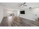 Bright open-concept living room with hardwood floors, a ceiling fan, and a view of the kitchen at 1671 Indy Dr, North Charleston, SC 29405