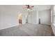 Spacious main bedroom featuring ensuite bath, plush carpet, ceiling fan and natural light at 1671 Indy Dr, North Charleston, SC 29405