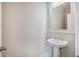 Clean powder room featuring a bright white pedestal sink with an elegant framed mirror at 1671 Indy Dr, North Charleston, SC 29405