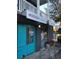 Mixon Market Storefront featuring a teal entry door, a sandwich board, and a second story balcony at 1671 Indy Dr, North Charleston, SC 29405