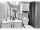 Neutral bathroom with bright white cabinets, modern sink and shower with a grey curtain at 172 Ashton Dr, Goose Creek, SC 29445