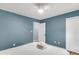 Well-lit bedroom featuring white ceiling fan, closet and painted in a modern blue at 172 Ashton Dr, Goose Creek, SC 29445