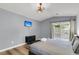 Comfortable bedroom with mounted TV, sliding glass door to porch, and modern gray decor at 172 Ashton Dr, Goose Creek, SC 29445